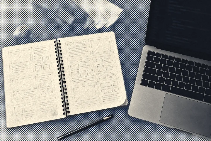 Halftone illustration of a design desk: a spiral sketchbook of page layouts, a pen and an open laptop.